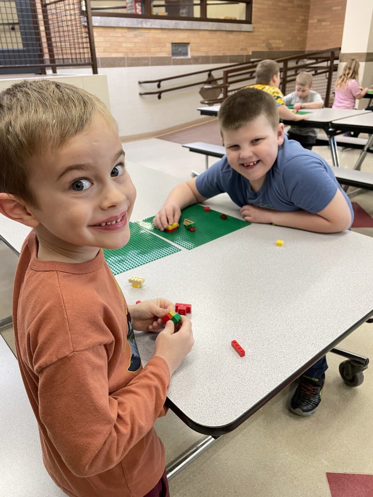 students smile at camera during afterschool program