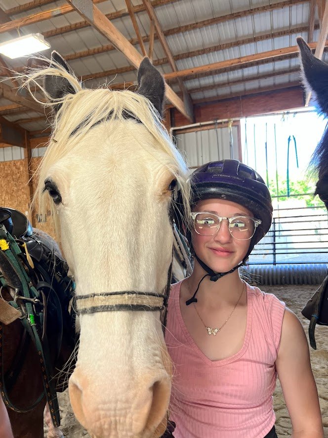 close up student and horse smile at camera