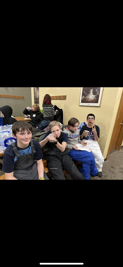 students warming up in the lodge while snowtubing.