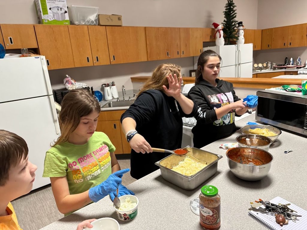 students work on community meal