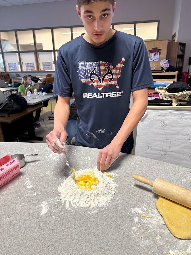 student makes home made pasta