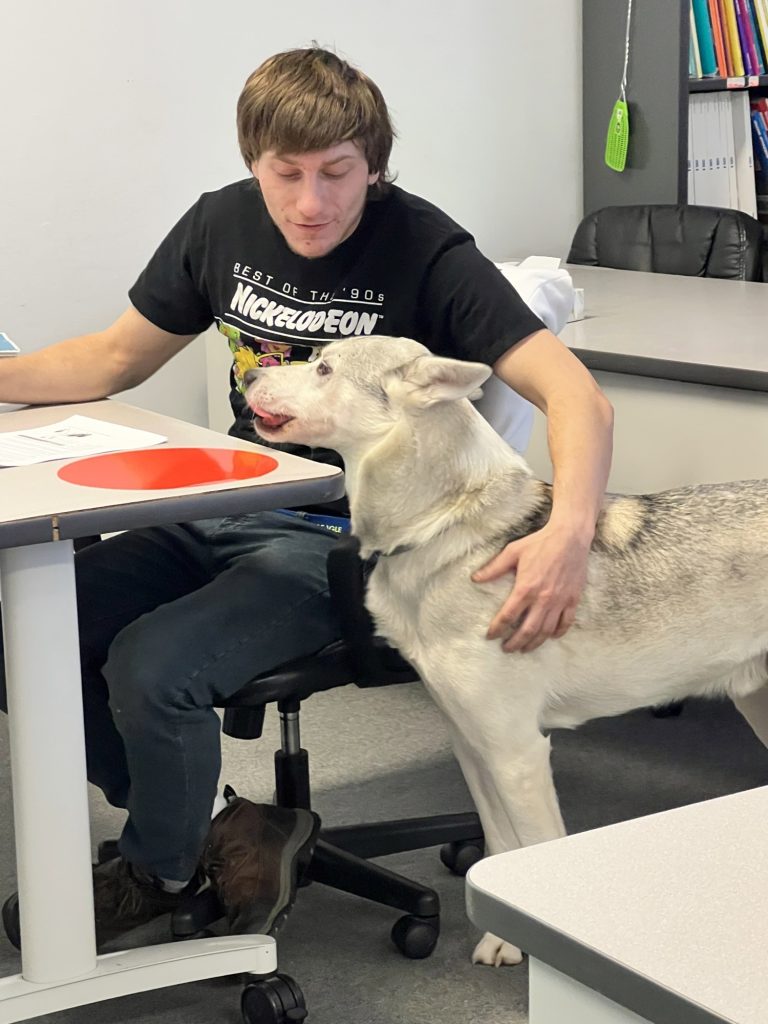 Student Alex works with support animal